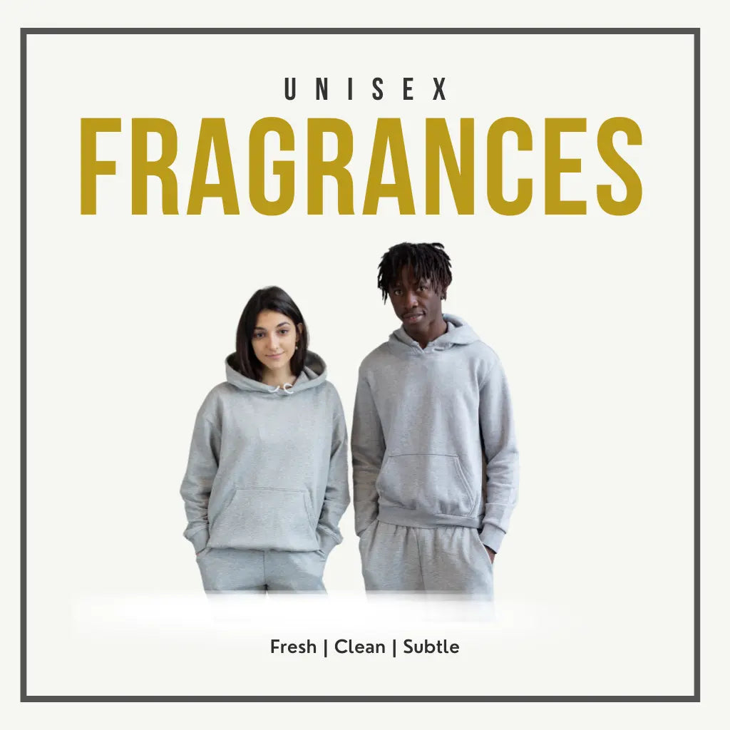 Two individuals wearing matching grey hoodies and pants stand side by side under bold gold text reading “UNISEX FRAGRANCES.” Below them, the phrase “Fresh | Clean | Subtle” defines the neutral, shared essence of the scent line