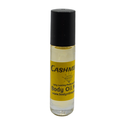 Cashmere Body Oil by Body Oil Nupe, roll-on bottle of body oil with a black cap and yellow label on a white background, soft yellow fragrance oil, long-lasting body fresh and clean oil fragrance 
