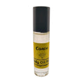 A clear bottle with a black cap labeled 'Coach' containing amber body oil. Long-lasting fragrance from Body Oil Nupe