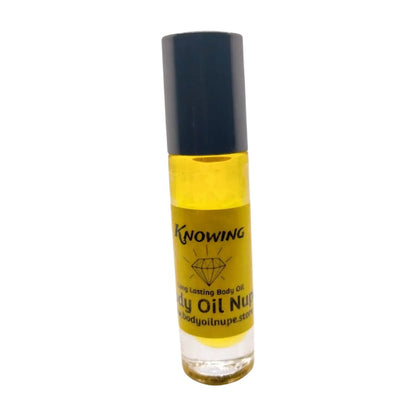 A clear bottle containing yellow liquid, presumably the body oil fragrance 'Knowing by Body Oil Nupe'. The bottle has a black cap and a label with the product name and branding. Long-lasting fragrance from Body Oil Nupe