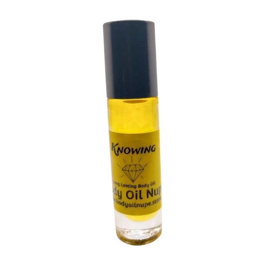 A clear bottle containing yellow liquid, presumably the body oil fragrance 'Knowing by Body Oil Nupe'. The bottle has a black cap and a label with the product name and branding. Long-lasting fragrance from Body Oil Nupe