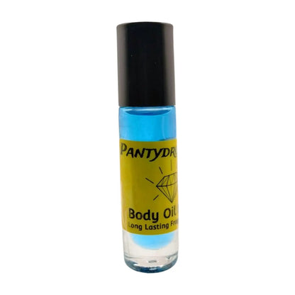 A clear bottle of Body Oil Nupe with a dark blue liquid visible inside, labeled as 'PANTYDRPPER' with additional text 'Long Lasting Fragrance'. The background is white. Long-lasting blue body oil fragrance in glass bottle