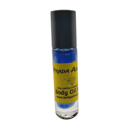 A bottle of Prada Amber body oil with a dark bluish-purple label and cap, set against a white background. Blue scent inside of glass bottle 