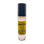 A bottle of Prada Candy Women's Fragrance Body Oil with a clear liquid visible inside, sealed with a black cap and labeled with the product name and brand.