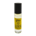 Roll-on bottle of Yara body oil with a black cap on a white background in glass bottle roll-on bottle